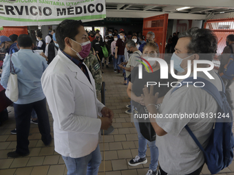 Medical personnel offer reports to people in a vaccination unit at the Constitución de 1917 metro station in Mexico City, where the AstraZen...