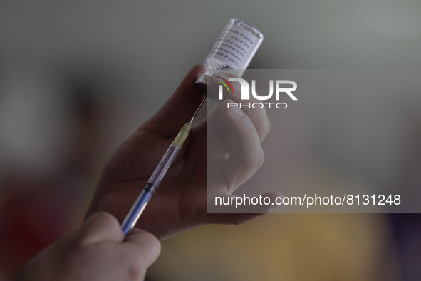 A nurse loads a syringe in a vaccination unit at the Constitución de 1917 metro station in Mexico City, where the AstraZeneca biological is...