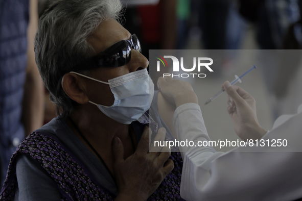 A nurse applies AstraZeneca vaccine to a person in a vaccination unit at the Constitutción de 1917 metro station in Mexico City, where peopl...