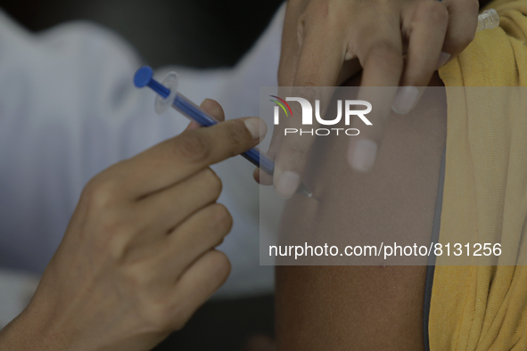 A nurse applies AstraZeneca vaccine to a person in a vaccination unit at the Constitutción de 1917 metro station in Mexico City, where peopl...