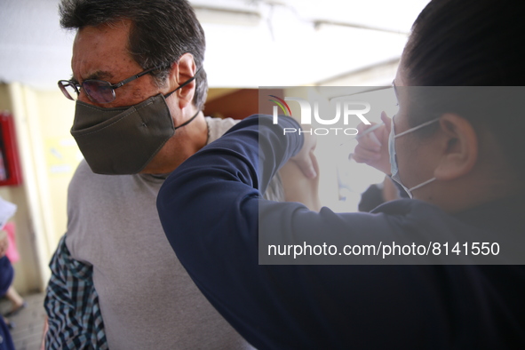 A person receives a Covid-19 booster dose during a vaccination program in the local markets as attempt to reduce risk of contagion. On April...