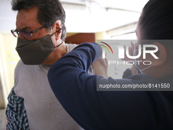 A person receives a Covid-19 booster dose during a vaccination program in the local markets as attempt to reduce risk of contagion. On April...