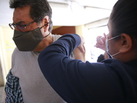 A person receives a Covid-19 booster dose during a vaccination program in the local markets as attempt to reduce risk of contagion. On April...