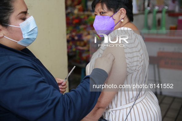 A person receives a Covid-19 booster dose during a vaccination program in the local markets as attempt to reduce risk of contagion. On April...