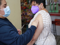 A person receives a Covid-19 booster dose during a vaccination program in the local markets as attempt to reduce risk of contagion. On April...