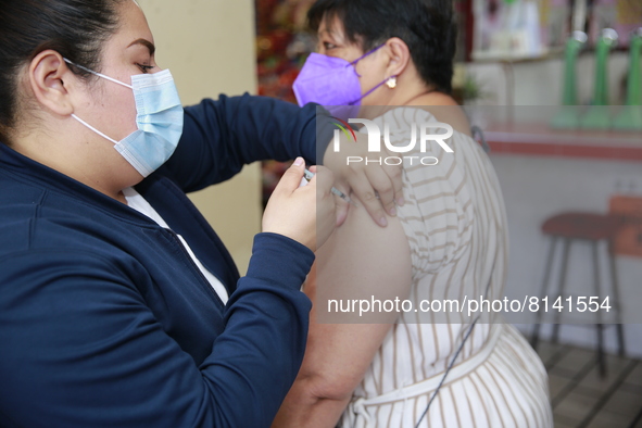 A person receives a Covid-19 booster dose during a vaccination program in the local markets as attempt to reduce risk of contagion. On April...