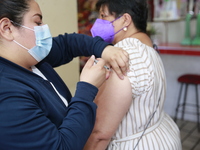 A person receives a Covid-19 booster dose during a vaccination program in the local markets as attempt to reduce risk of contagion. On April...