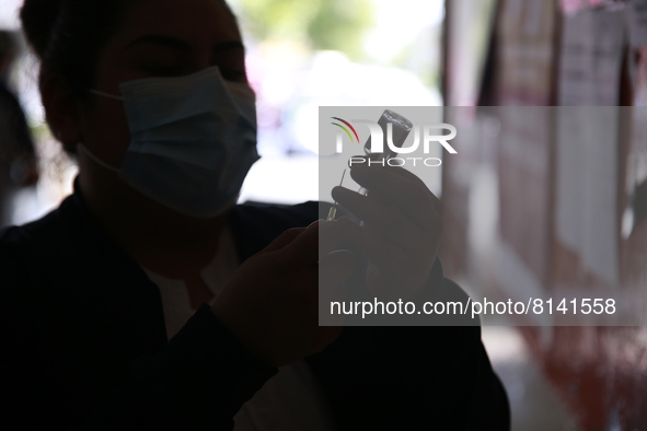 A nurse prepares a Covid-19 dose during a vaccination program in the local markets as attempt to reduce risk of contagion. On April 27, 2022...