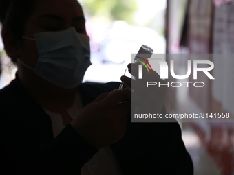 A nurse prepares a Covid-19 dose during a vaccination program in the local markets as attempt to reduce risk of contagion. On April 27, 2022...