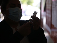 A nurse prepares a Covid-19 dose during a vaccination program in the local markets as attempt to reduce risk of contagion. On April 27, 2022...