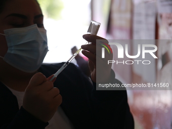 A nurse prepares a Covid-19 dose during a vaccination program in the local markets as attempt to reduce risk of contagion. On April 27, 2022...