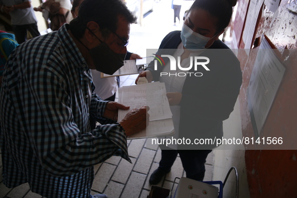 A Person fill out a form preview to receive a  Covid-19 booster dose during a vaccination program in the local markets as attempt to reduce...