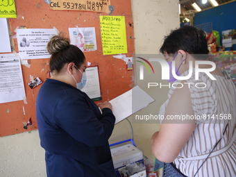 A Person fill out a form preview to receive a  Covid-19 booster dose during a vaccination program in the local markets as attempt to reduce...