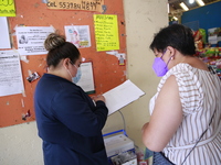 A Person fill out a form preview to receive a  Covid-19 booster dose during a vaccination program in the local markets as attempt to reduce...