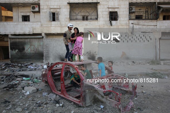 Malik Sabag a 15-year-old Syrian civil defense member, Malik is playing on damaged car with his brothers and friends at Al-mashhad district...