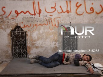 Malik Sabag a 15-year-old Syrian civil defense, Malik is Having some break time in the civil defense center at Bab al-nairab neighborhood di...
