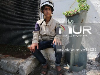 Malik Sabag a 15-year-old Syrian civil defense member, Malik is sitting next to unexploded bomb which is planted with flowers and this bomb...