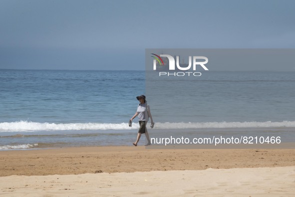 A person is seen performing outdoor activities on the coastline of Carcavelos Beach. Lisbon, May 09, 2022. Two months after the lifting of t...