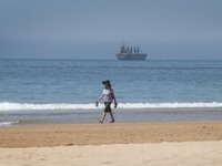 A person is seen performing outdoor activities on the coastline of Carcavelos Beach. Lisbon, May 09, 2022. Two months after the lifting of t...