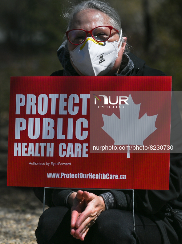 A protester holds a placard with words 'Protect Public Health Care'.
Health-care workers, activists and their supporters protested this afte...