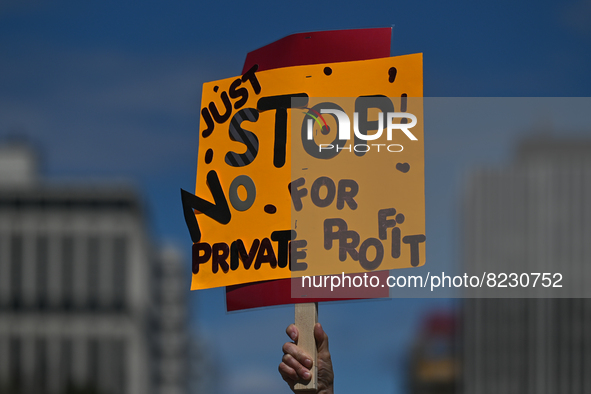 A protester holds a placard with words 'Just STOP. No For Private Profit'.
Health-care workers, activists and their supporters protested thi...