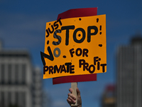 A protester holds a placard with words 'Just STOP. No For Private Profit'.
Health-care workers, activists and their supporters protested thi...