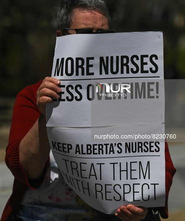 A protester holds a placard with words 'More Nurses Less Overtime!'.
Health-care workers, activists and their supporters protested this afte...