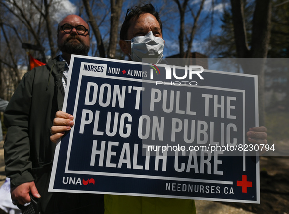 A protester holds a placard with words 'Don't Pull The Plug On Public Health Care'.
Health-care workers, activists and their supporters prot...