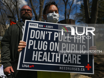 A protester holds a placard with words 'Don't Pull The Plug On Public Health Care'.
Health-care workers, activists and their supporters prot...