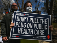 A protester holds a placard with words 'Don't Pull The Plug On Public Health Care'.
Health-care workers, activists and their supporters prot...