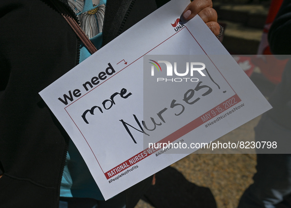 A protester holds a placard with words 'We need more Nurses!'.
Health-care workers, activists and their supporters protested this afternoon...