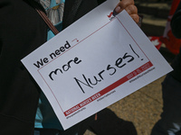 A protester holds a placard with words 'We need more Nurses!'.
Health-care workers, activists and their supporters protested this afternoon...