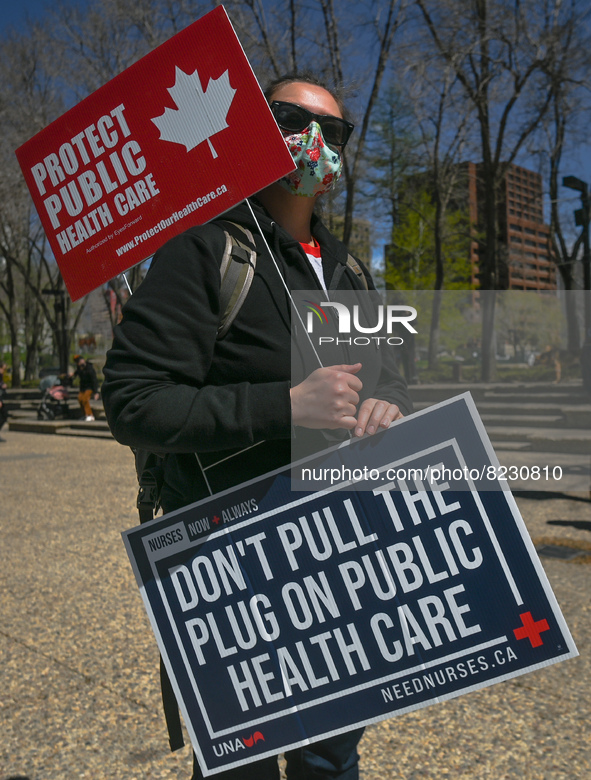 A protester holds a placard with words 'Protect Public Health Care'.
Health-care workers, activists and their supporters protested this afte...