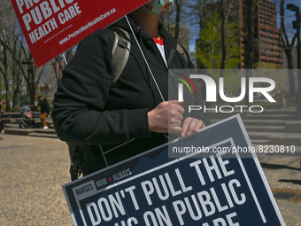 A protester holds a placard with words 'Protect Public Health Care'.
Health-care workers, activists and their supporters protested this afte...