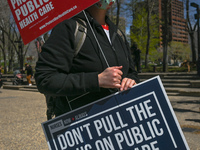 A protester holds a placard with words 'Protect Public Health Care'.
Health-care workers, activists and their supporters protested this afte...