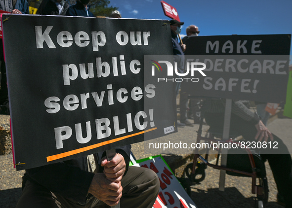 Protesters hold placards with words Keep our public Services Public!' and 'Make Eldercare Safe!.
Health-care workers, activists and their su...