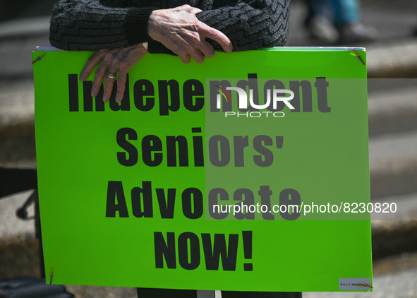 A protester holds a placard with words 'Independent Seniors' Advocate NOW!'.
Health-care workers, activists and their supporters protested t...