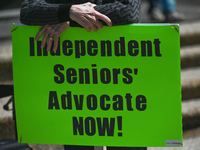 A protester holds a placard with words 'Independent Seniors' Advocate NOW!'.
Health-care workers, activists and their supporters protested t...