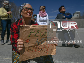 A protester holds a placard with words 'People Not Profit'.
Health-care workers, activists and their supporters protested this afternoon dur...