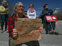 A protester holds a placard with words 'People Not Profit'.
Health-care workers, activists and their supporters protested this afternoon dur...