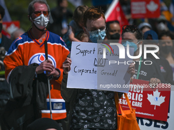 A protester holds a placard with words 'Support Public Health NOT Corporate Greed!'.
Health-care workers, activists and their supporters pro...