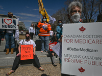 Health-care workers, activists and their supporters protest against Premier Kenney and the UCP government that are taking steps to privatize...