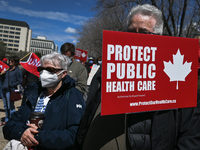 Health-care workers, activists and their supporters protest against Premier Kenney and the UCP government that are taking steps to privatize...