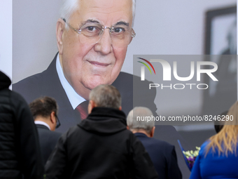 People stay in a queue under the portrait of Leonid Kravchuk in Kyiv, Ukraine, May 17, 2022. Dozens of politicians, artists, scientists and...