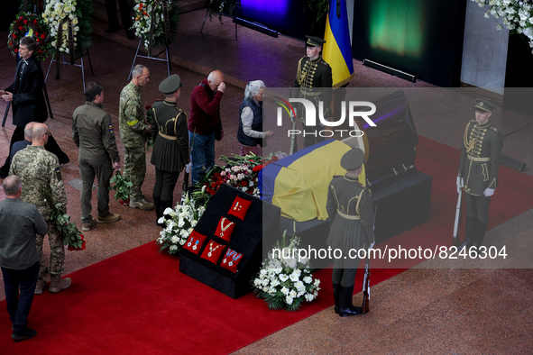 People lay flowers near the coffin with the body of Leonid Kravchuk in Kyiv, Ukraine, May 17, 2022. Dozens of politicians, artists, scientis...