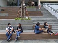 People wearing a protective mask walk in Jakarta, Indonesia, on May 18, 2022 amid the COVID-19 pandemic. (