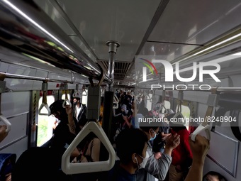 People wearing a protective mask walk in Jakarta, Indonesia, on May 18, 2022 amid the COVID-19 pandemic. (