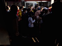 People wearing a protective mask walk in Jakarta, Indonesia, on May 18, 2022 amid the COVID-19 pandemic. (