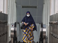 People wearing a protective mask walk in Jakarta, Indonesia, on May 18, 2022 amid the COVID-19 pandemic. (