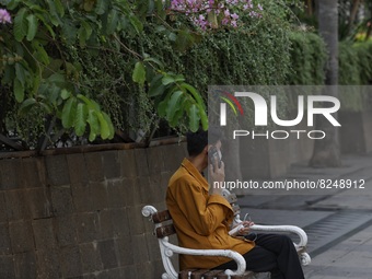 People wearing a protective mask walk in Jakarta, Indonesia, on May 18, 2022 amid the COVID-19 pandemic. (